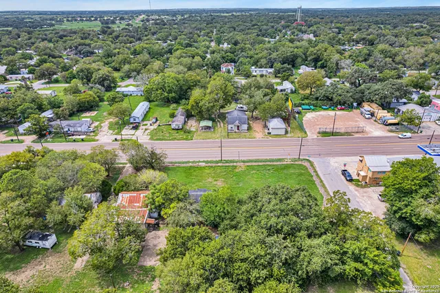 an aerial view of a house with a yard