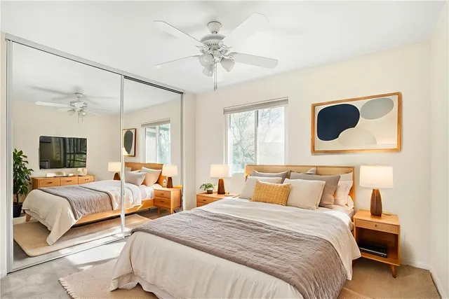 a bedroom with two beds and a window