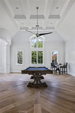a living room with furniture and floor to ceiling window