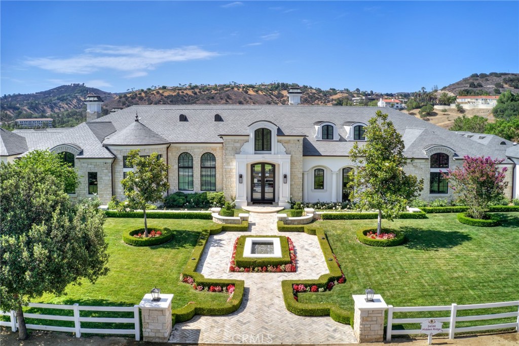 24100 Hidden Ridge Road Hidden Hills, CA 91302 - Photo 2 of 15 an aerial view of a house with swimming pool garden and lake view