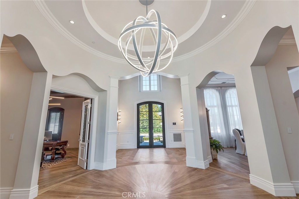 24100 Hidden Ridge Road Hidden Hills, CA 91302 - Photo 5 of 15 a view of a hallway with entryway dining room and chandelier