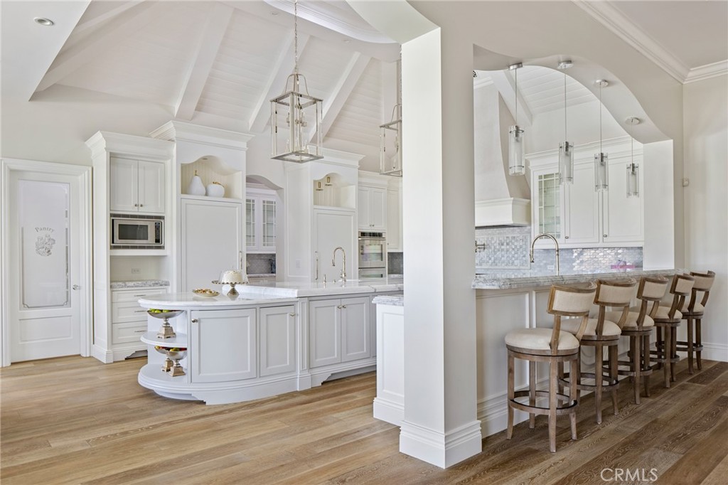 24100 Hidden Ridge Road Hidden Hills, CA 91302 - Photo 7 of 15 a room with lots of wooden furniture and cabinets
