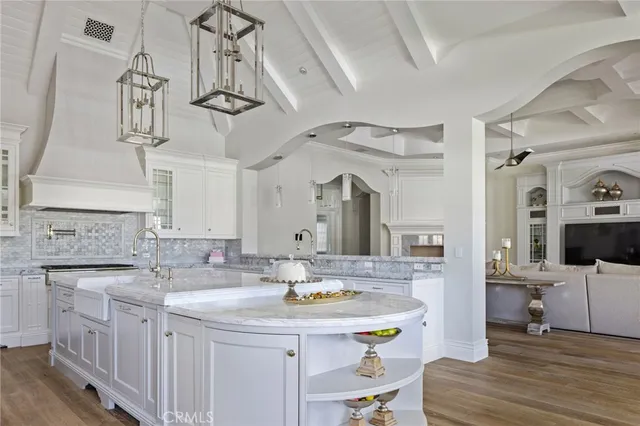 a kitchen with kitchen island a sink counter space and living room view