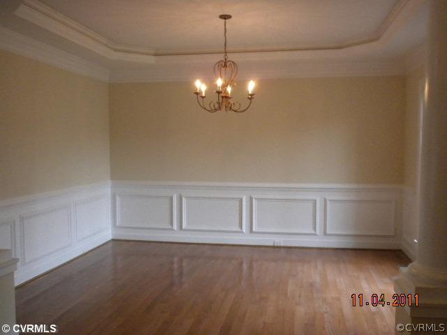 516 Hunt Field Road Manakin-Sabot, VA 23103 - Photo 2 of 9 a view of an empty room with chandelier fan and kitchen view