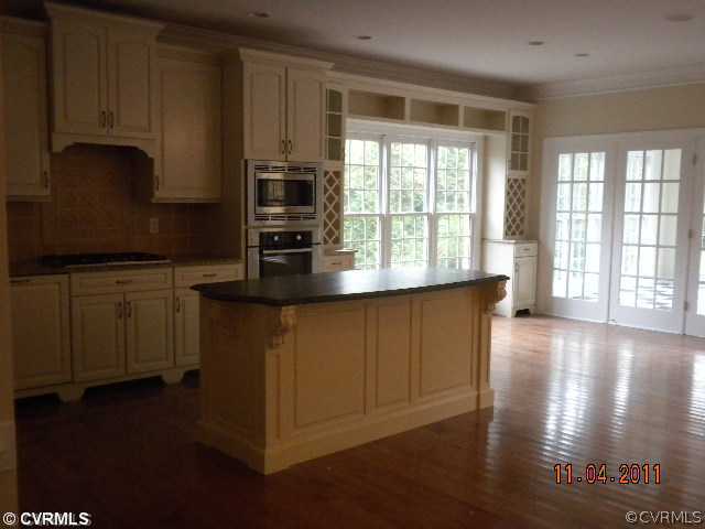 516 Hunt Field Road Manakin-Sabot, VA 23103 - Photo 3 of 9 a kitchen with stainless steel appliances granite countertop a stove a sink a refrigerator white cabinets and wooden floor