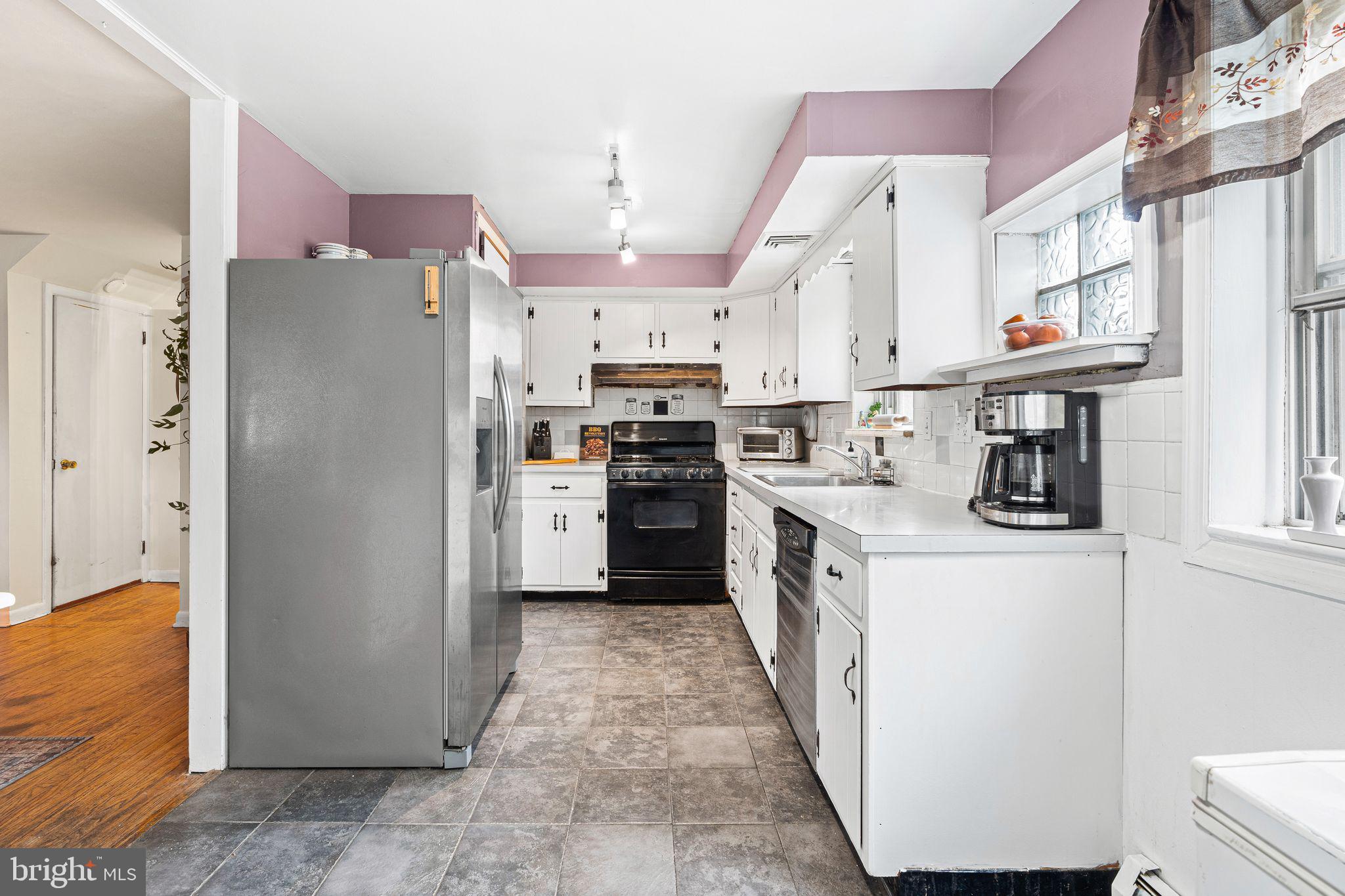 2 Waverly Road Havertown, PA 19083 - Photo 6 of 30 a kitchen with stainless steel appliances a refrigerator a sink a stove top oven a counter space and cabinets