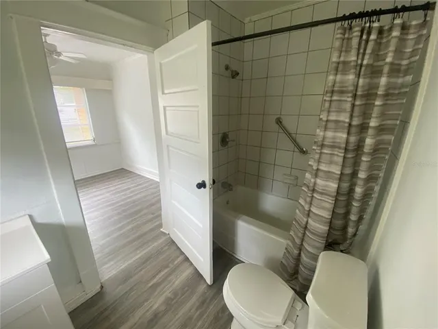 a bathroom with a toilet and a shower
