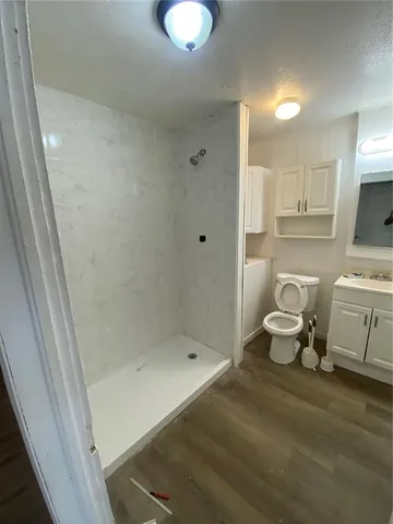 a bathroom with a sink toilet and shower
