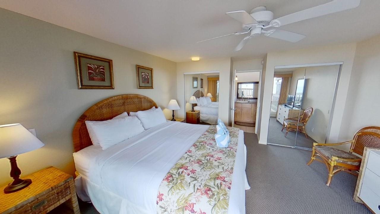 4909 Lower Honoapiilani Road, Unit E4 Lahaina, HI 96761 - Photo 12 of 30 a bedroom with a bed and wooden floor