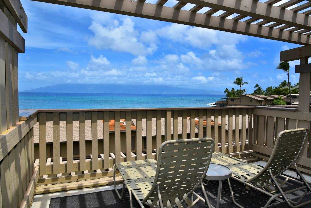 4909 Lower Honoapiilani Road, Unit E4 Lahaina, HI 96761 - Photo 13 of 30 a view of a chairs and table in patio