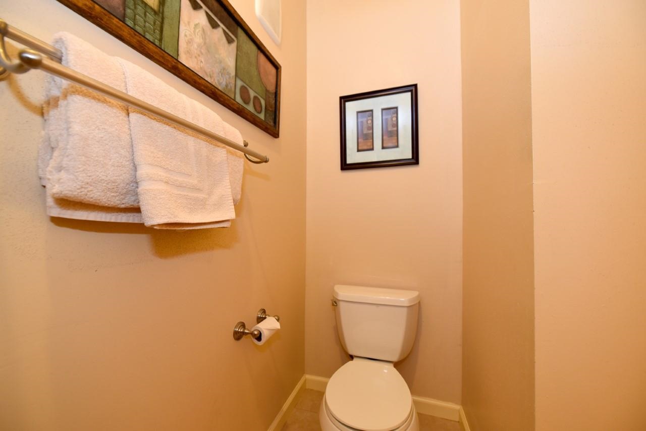 4909 Lower Honoapiilani Road, Unit E4 Lahaina, HI 96761 - Photo 19 of 30 a white toilet sitting next to a blue wall