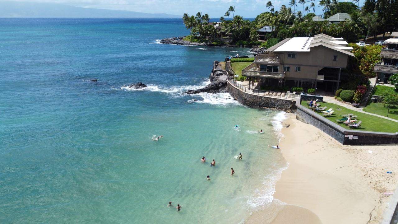 4909 Lower Honoapiilani Road, Unit E4 Lahaina, HI 96761 - Photo 29 of 30 a view of a swimming pool with lawn chairs and a yard