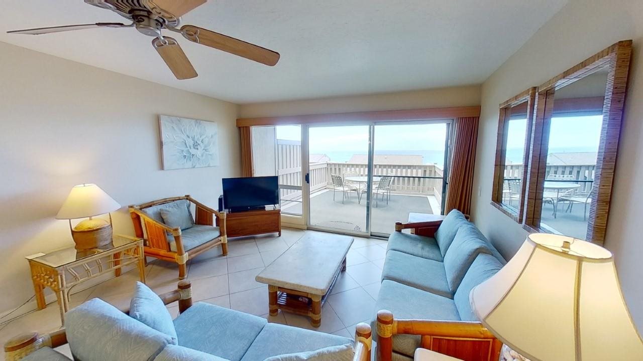 4909 Lower Honoapiilani Road, Unit E4 Lahaina, HI 96761 - Photo 3 of 30 a living room with furniture and a large window