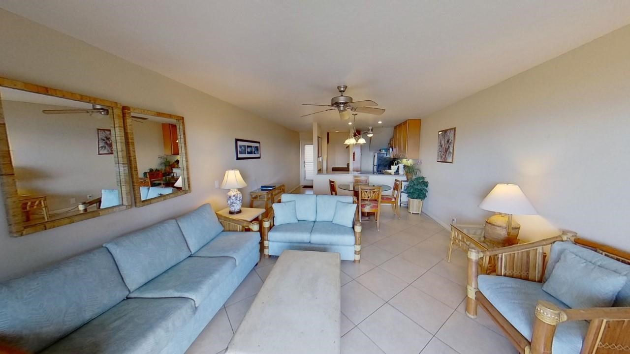4909 Lower Honoapiilani Road, Unit E4 Lahaina, HI 96761 - Photo 4 of 30 a living room with furniture and a chandelier