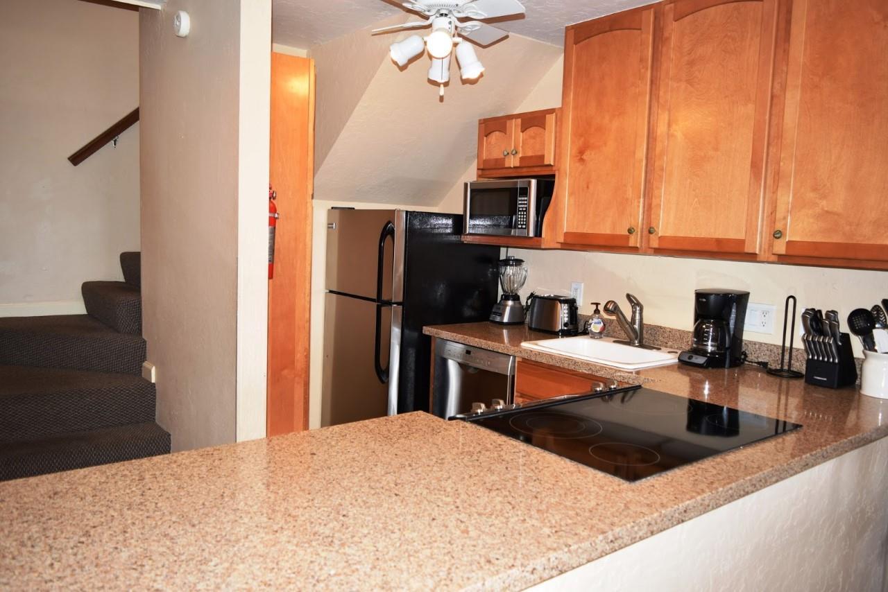 4909 Lower Honoapiilani Road, Unit E4 Lahaina, HI 96761 - Photo 6 of 30 a kitchen with a refrigerator and a sink