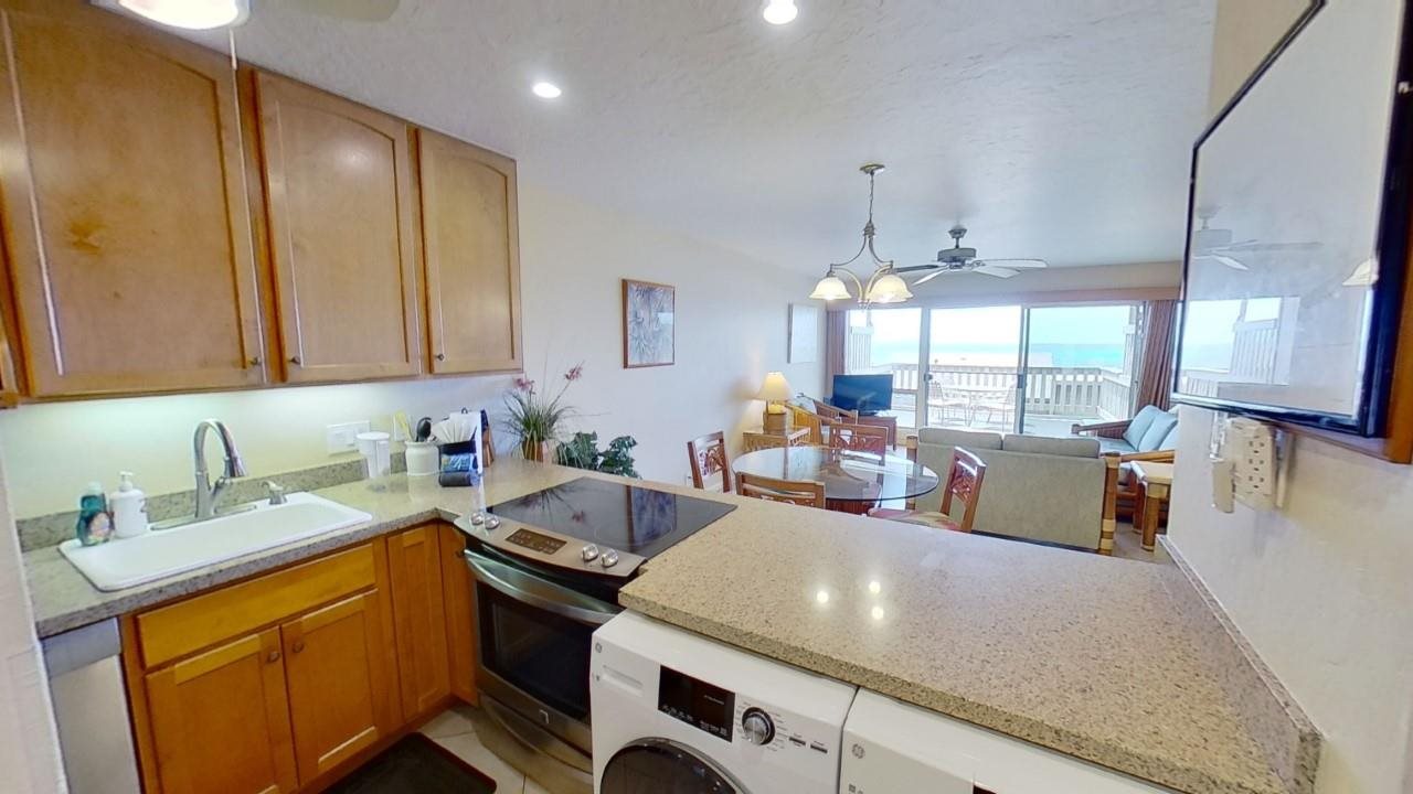 4909 Lower Honoapiilani Road, Unit E4 Lahaina, HI 96761 - Photo 7 of 30 a kitchen with a sink stove and cabinets