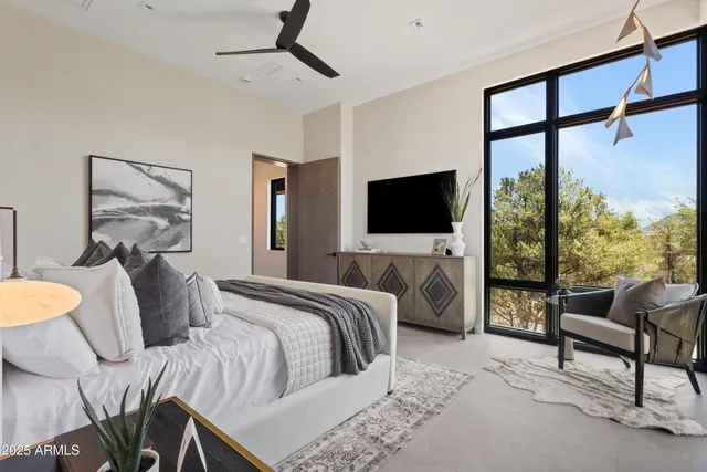 a bedroom with a bed and glass window