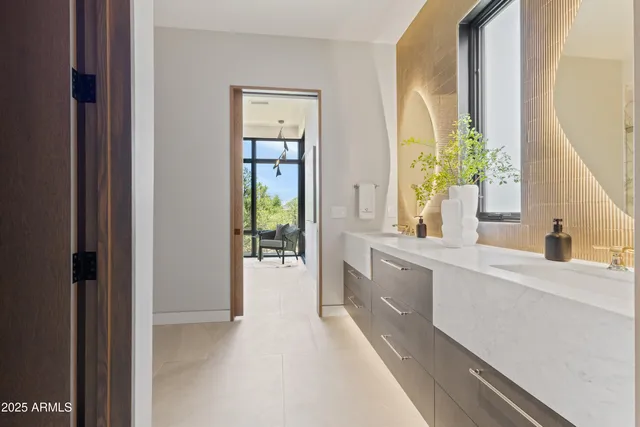 a large white kitchen with a sink and dish washer