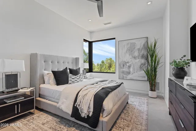 a bedroom with bed and a potted plant