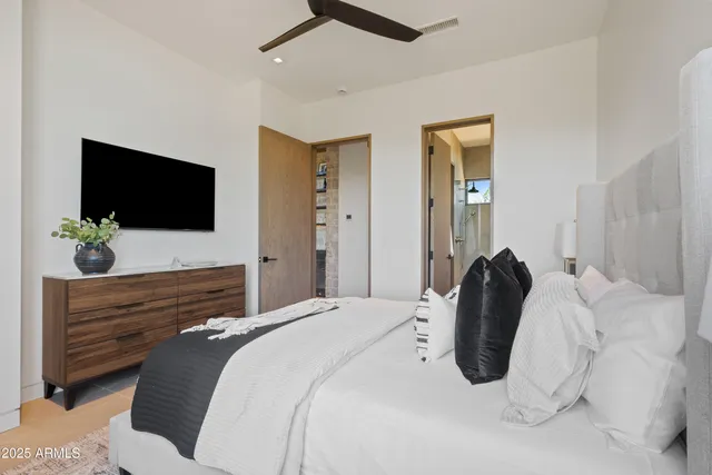 a bedroom with a bed and a flat screen tv