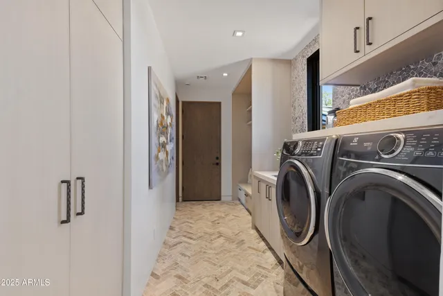 a view of a storage & utility room with dryer and washer