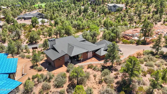 an aerial view of a house with a yard and trees
