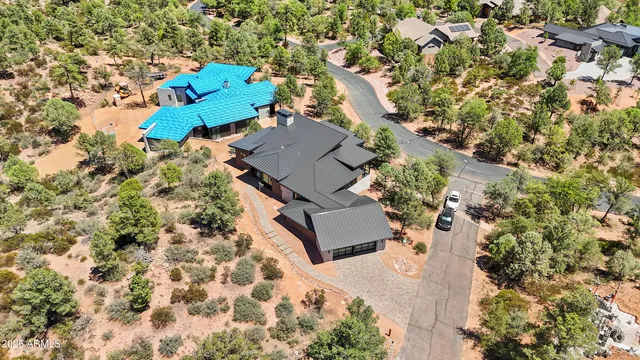 an aerial view of a house with a yard and trees