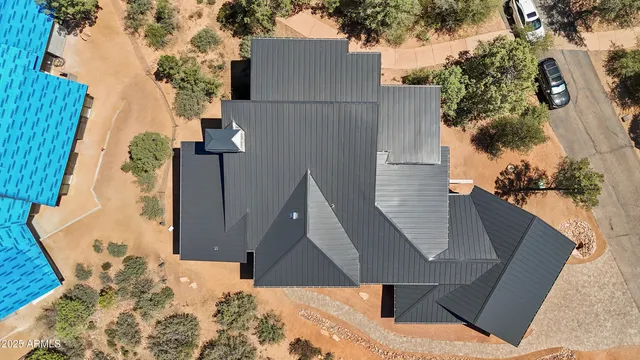 an aerial view of a house with a yard