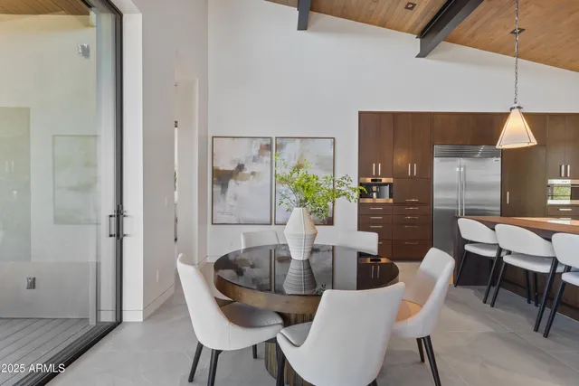a dining room with furniture and wooden floor
