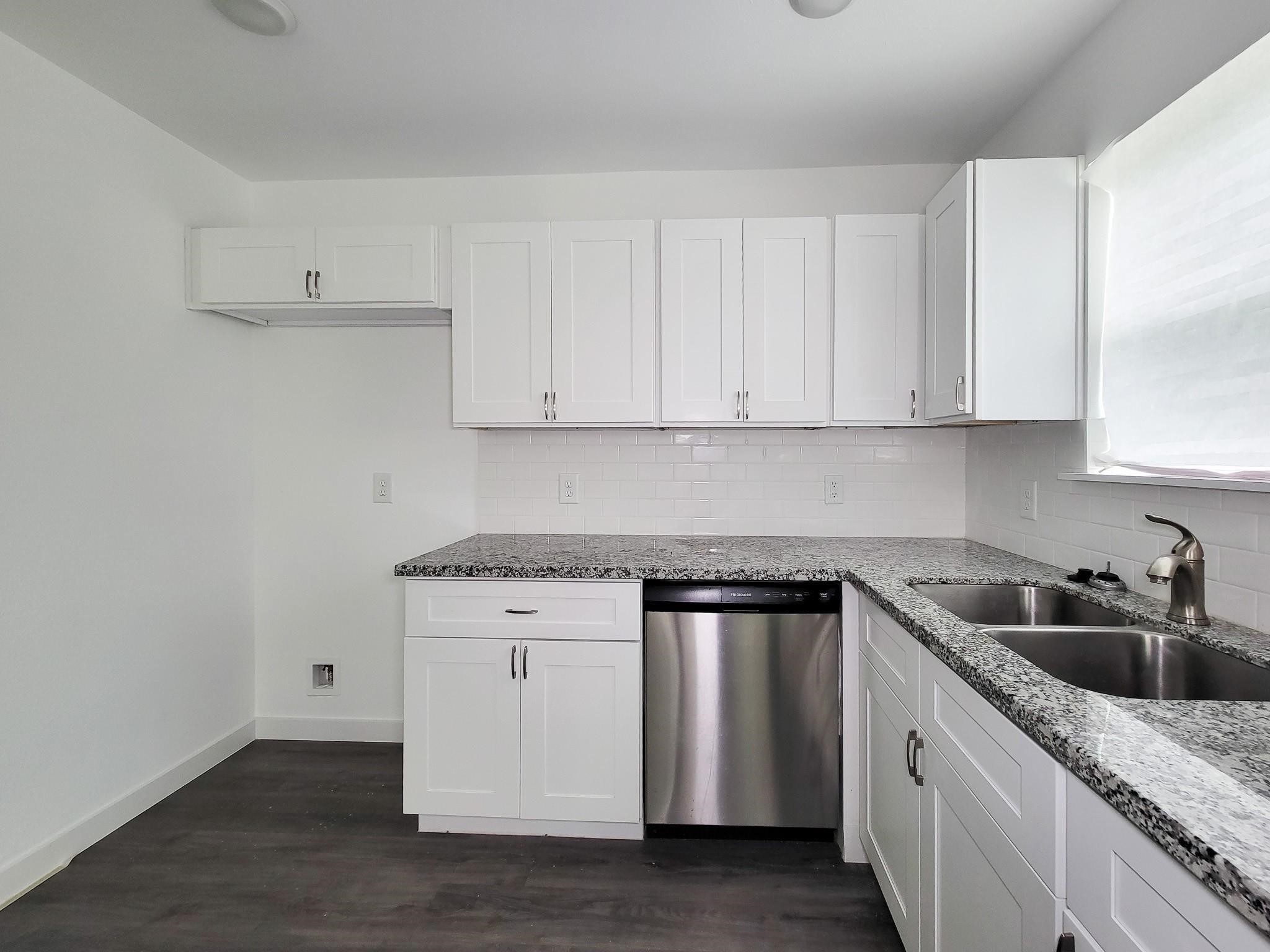 8122 Sterlingshire Street, Unit B Houston, TX 77078 - Photo 9 of 27 a kitchen with granite countertop white cabinets and a sink