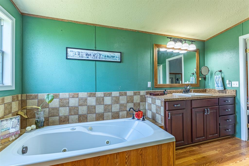 75 Southern Road Mineral Wells, TX 76067 - Photo 16 of 31 a bathroom with a sink and a bathtub