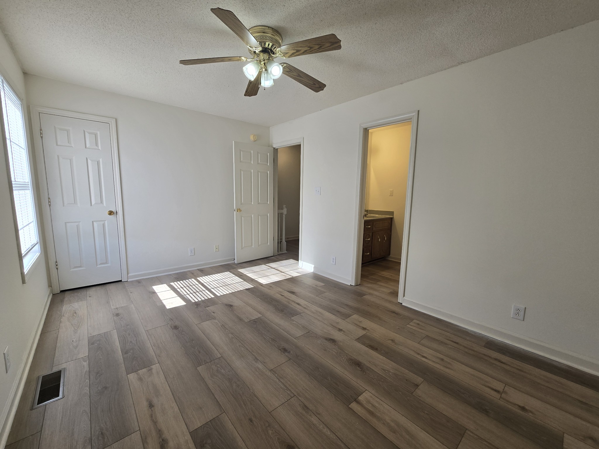223 Tree Line Drive Oak Grove, KY 42262 - Photo 16 of 18 an empty room with wooden floor and ceiling fan