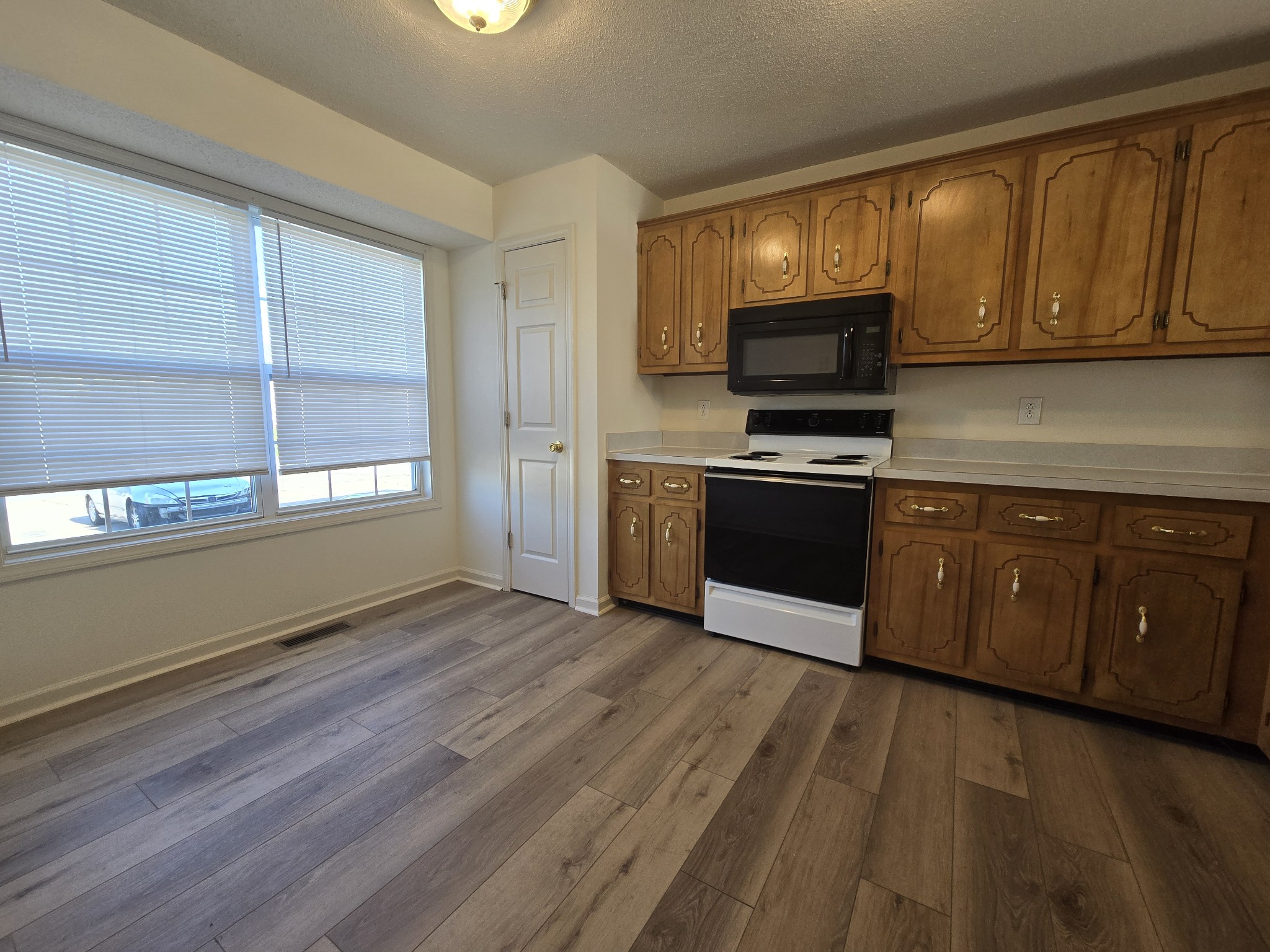 223 Tree Line Drive Oak Grove, KY 42262 - Photo 5 of 18 a kitchen with stainless steel appliances granite countertop wooden cabinets and a stove top oven