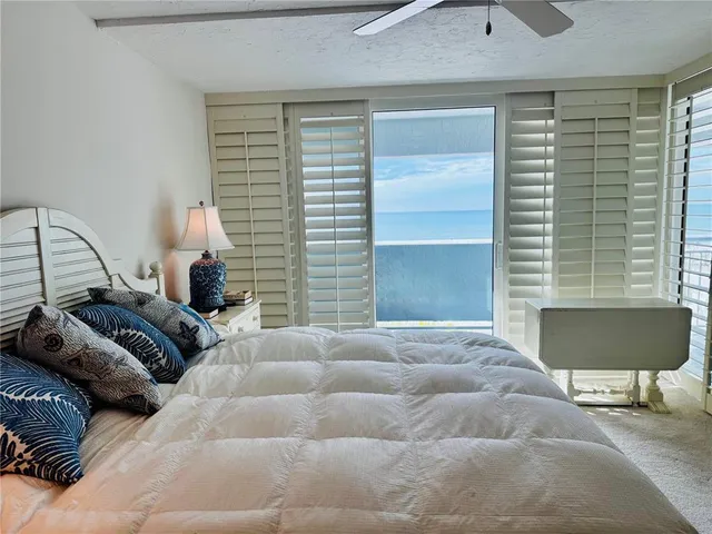 a bedroom with a bed and a chair