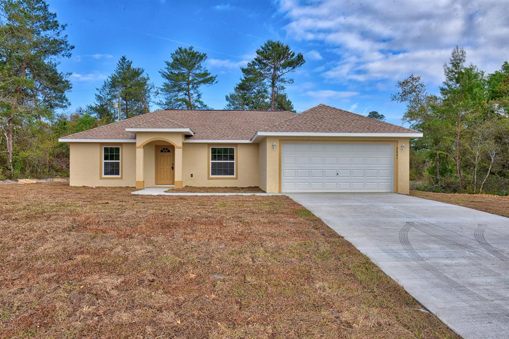 5257 Southwest 165th St Road Ocala, FL 34473 - Photo 1 of 1 a front view of a house with a yard and garage
