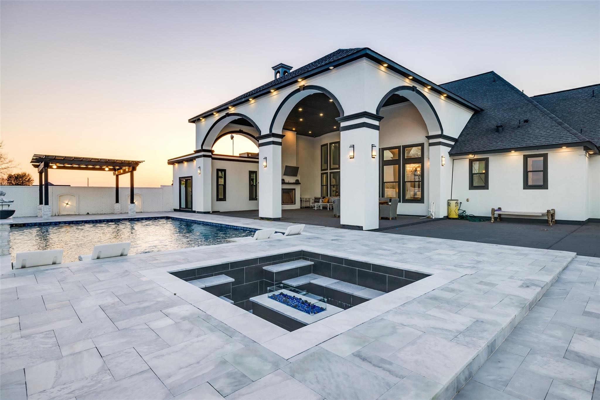 4821 Walters Road Richmond, TX 77469 - Photo 39 of 50 An entertainer’s dream backyard offering multiple gathering spaces, sunset views, and seamless indoor outdoor living in a private, luxurious setting.