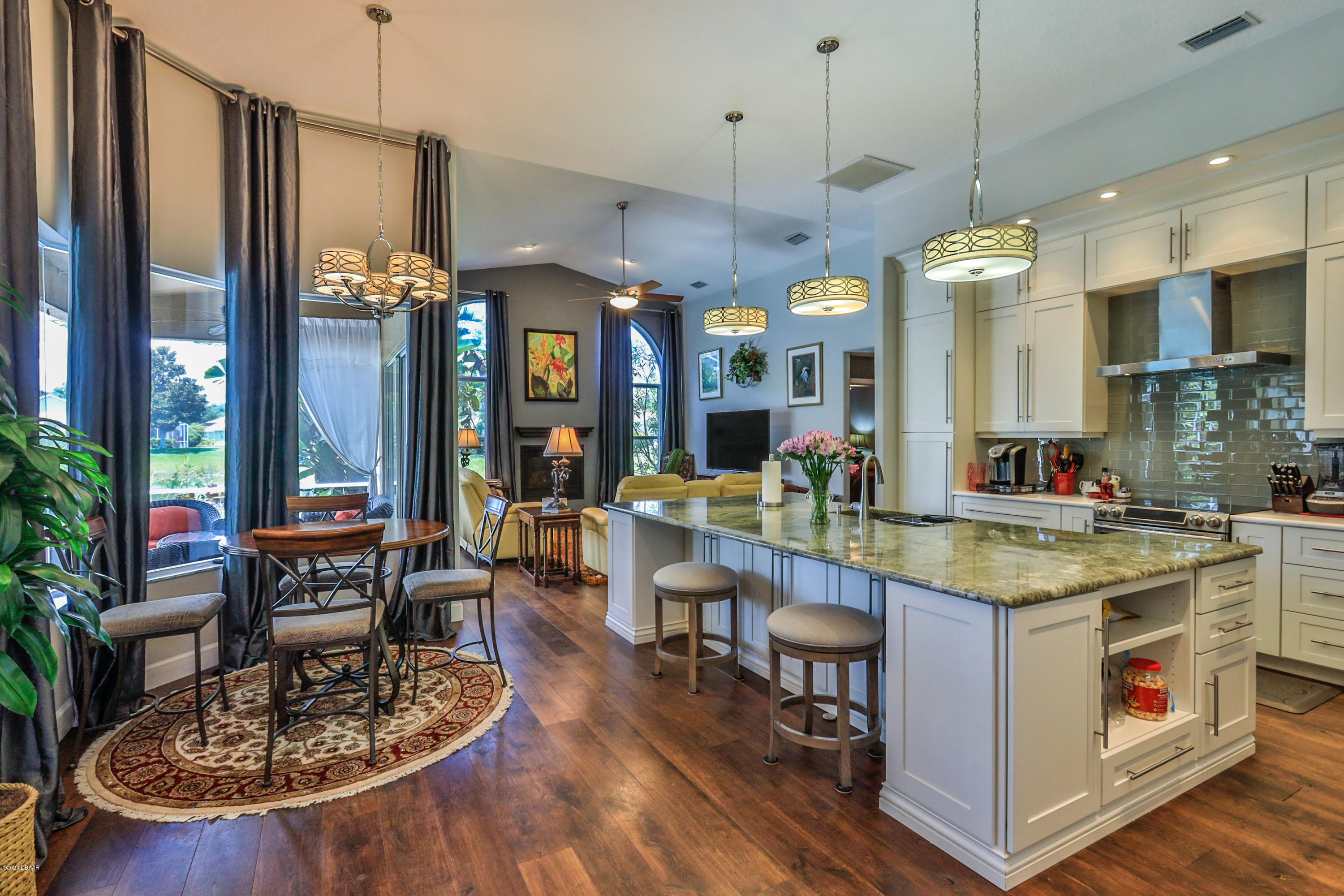 5 Creek Branch Way Ormond Beach, FL 32174 - Photo 13 of 42 a kitchen with stainless steel appliances granite countertop a stove and a wooden floors