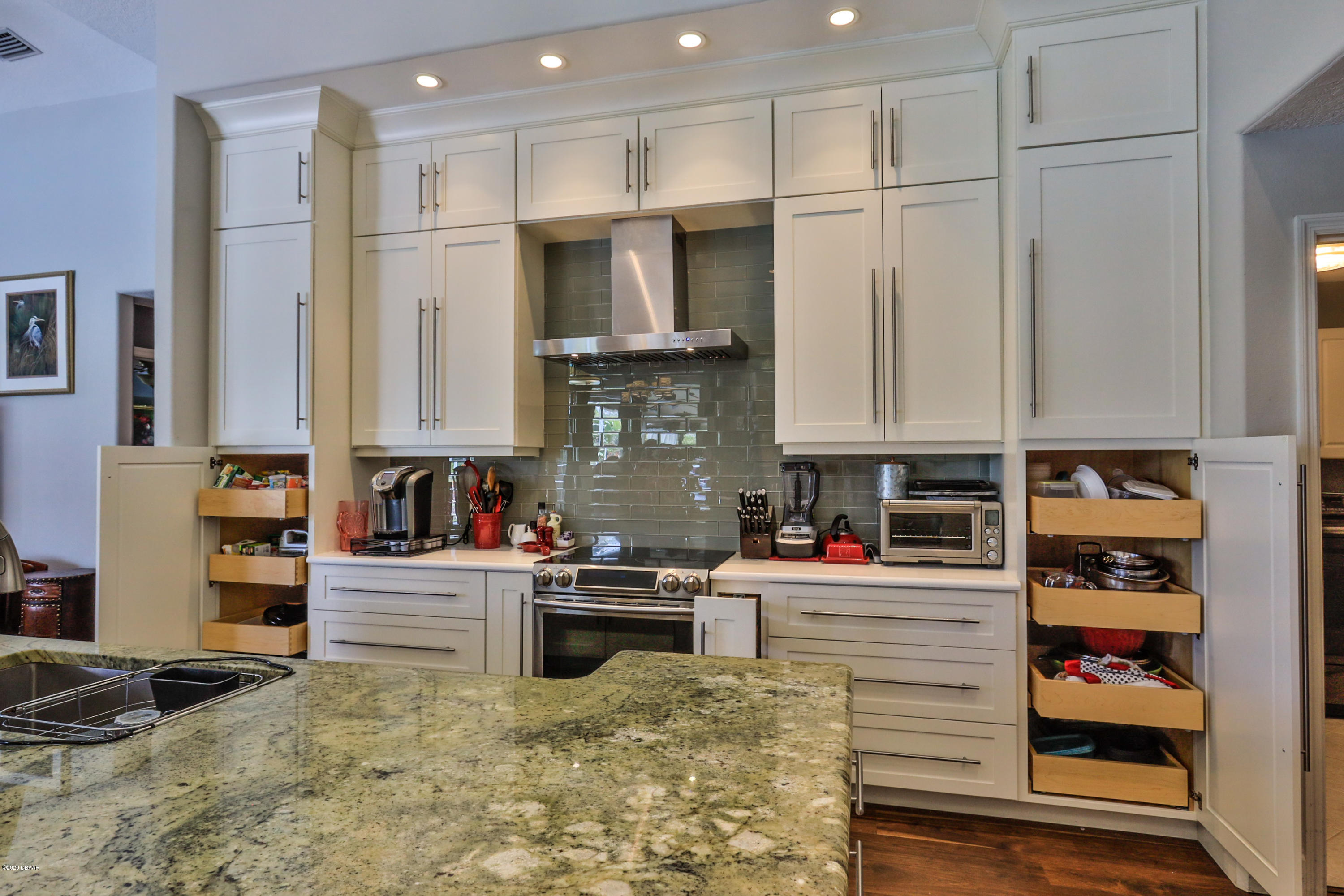 5 Creek Branch Way Ormond Beach, FL 32174 - Photo 19 of 42 a kitchen with stainless steel appliances granite countertop a refrigerator sink and cabinets