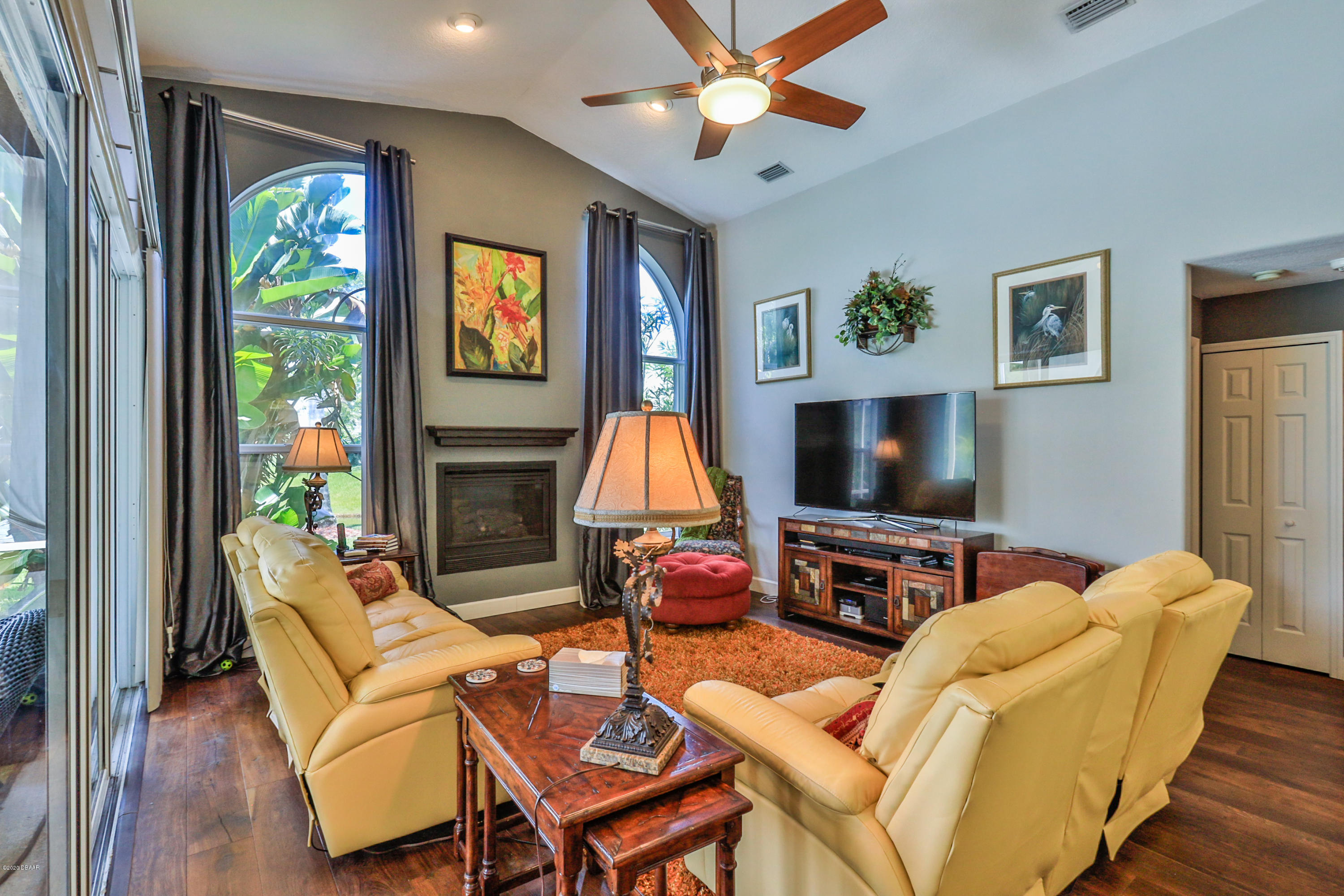 5 Creek Branch Way Ormond Beach, FL 32174 - Photo 21 of 42 a living room with furniture a flat screen tv and a fireplace