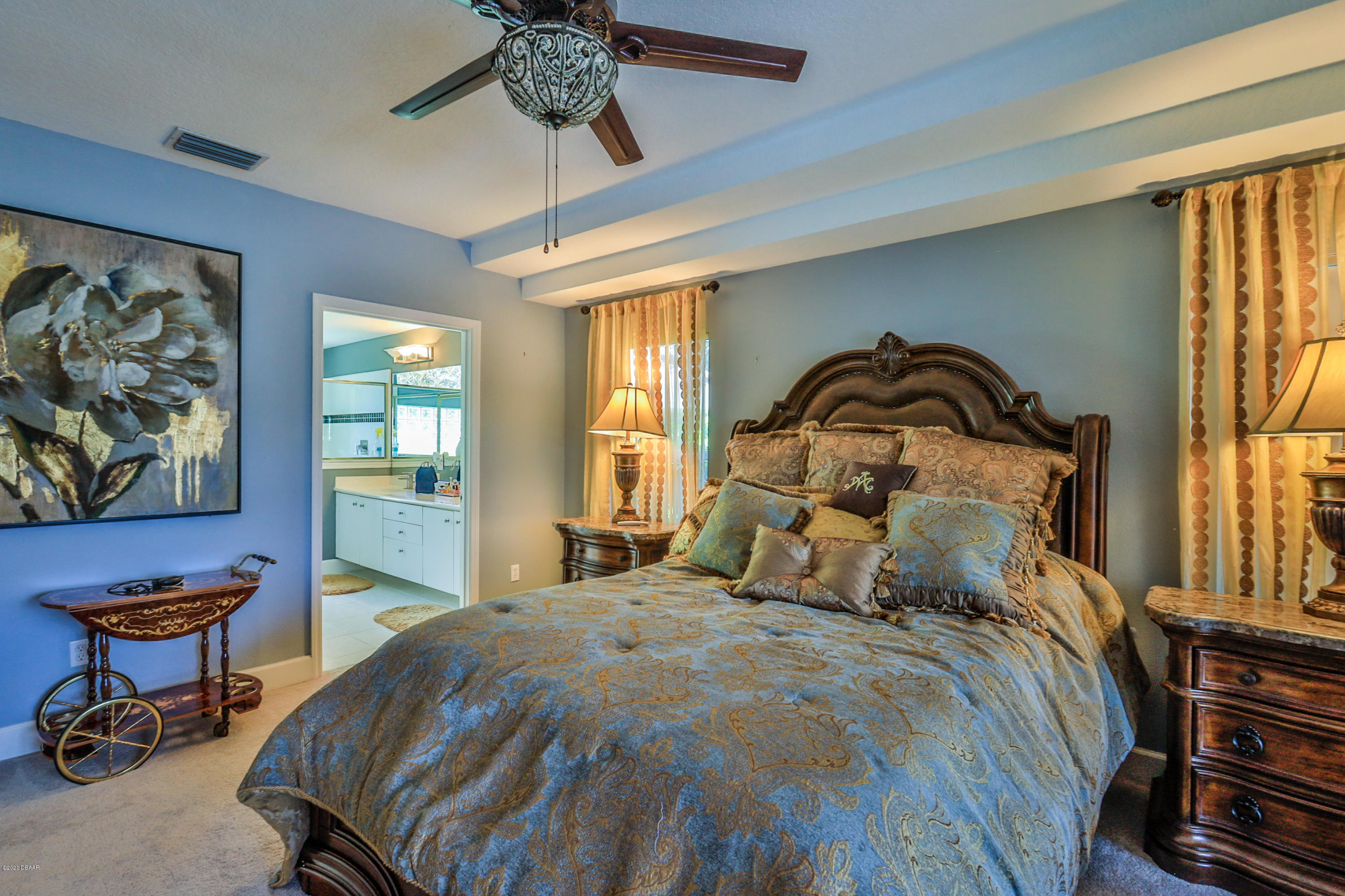 5 Creek Branch Way Ormond Beach, FL 32174 - Photo 24 of 42 a bedroom with a bed and a chandelier