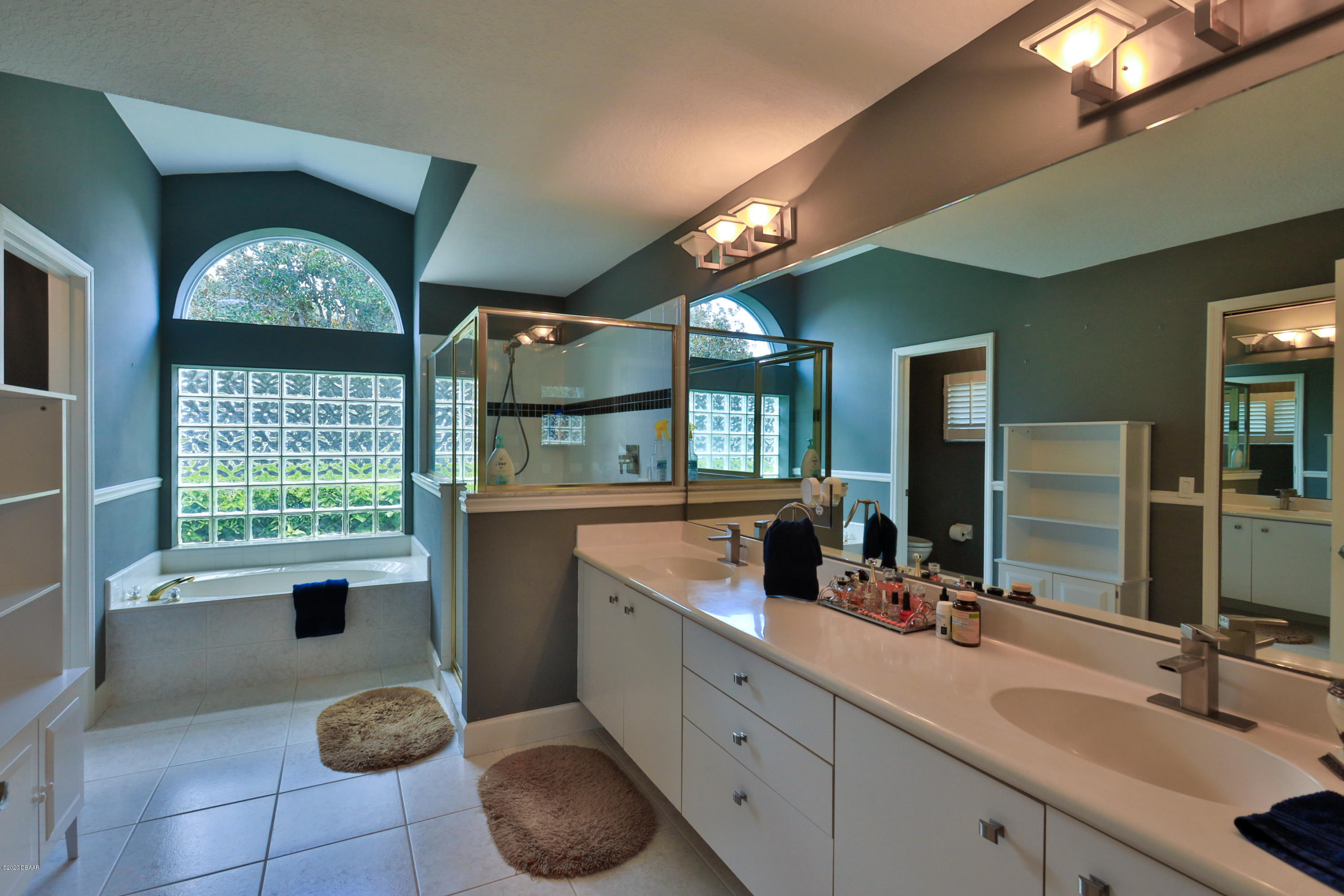 5 Creek Branch Way Ormond Beach, FL 32174 - Photo 25 of 42 a bathroom with a sink a large mirror and a window