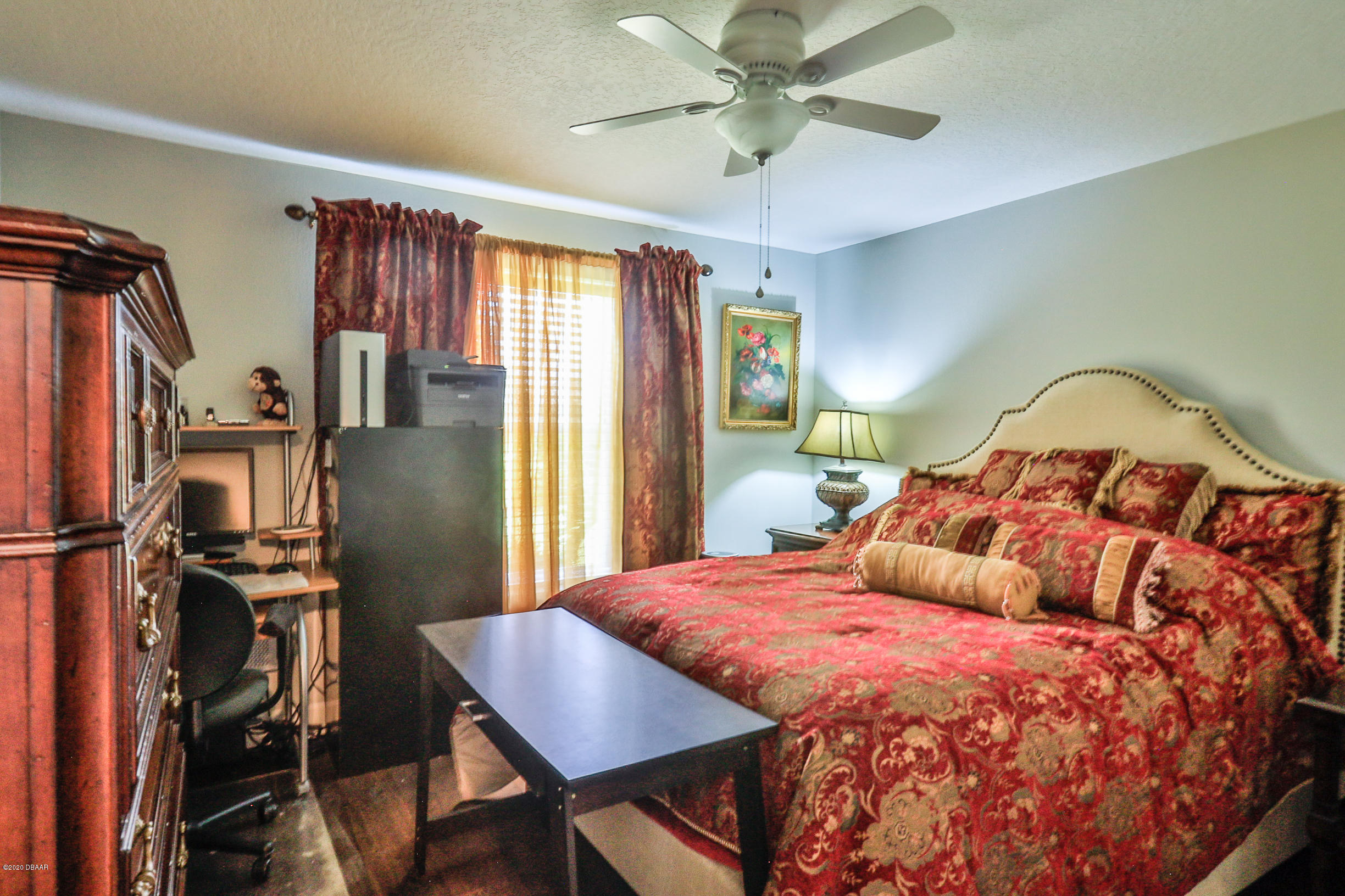 5 Creek Branch Way Ormond Beach, FL 32174 - Photo 32 of 42 a bedroom with a bed and a chandelier