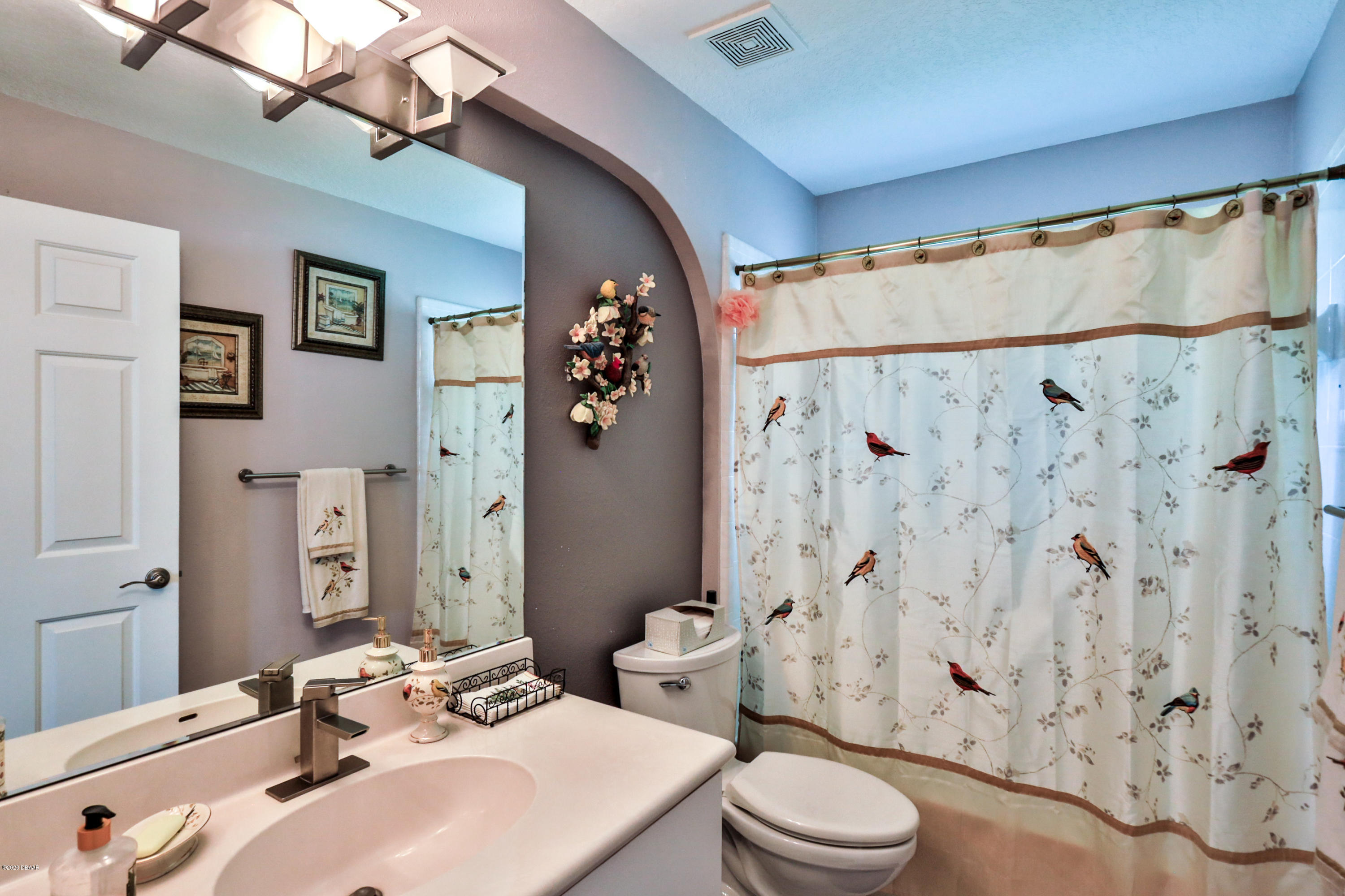 5 Creek Branch Way Ormond Beach, FL 32174 - Photo 33 of 42 a bathroom with a sink a toilet and shower curtain