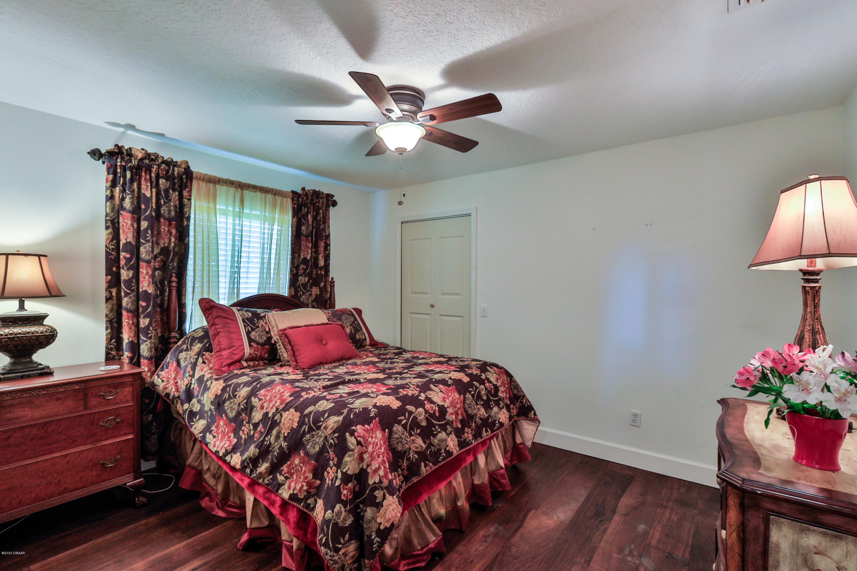 5 Creek Branch Way Ormond Beach, FL 32174 - Photo 34 of 42 a bedroom with a bed and a chandelier
