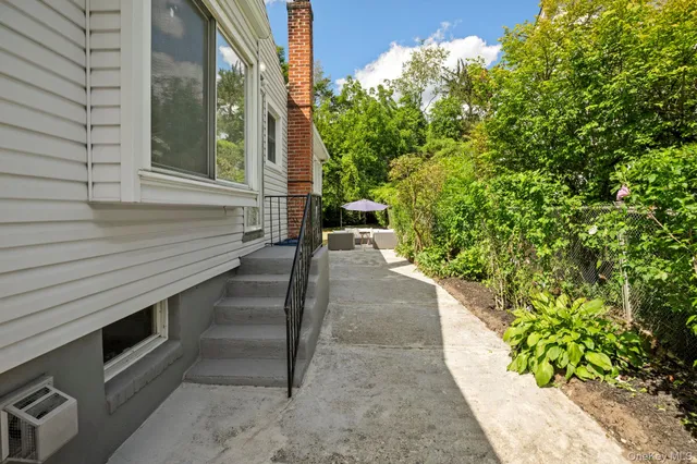 a view of a pathway of a house with a yard