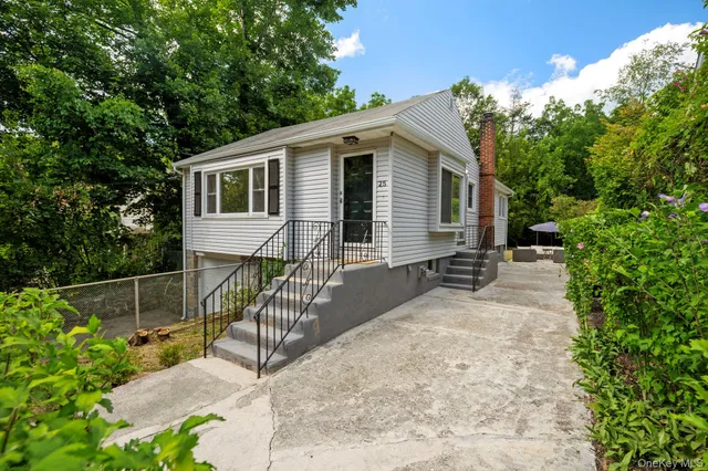 a view of a house with backyard and sitting area