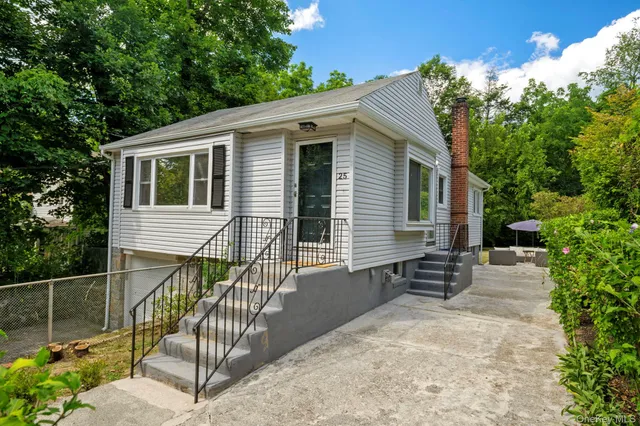 a view of a house with wooden fence