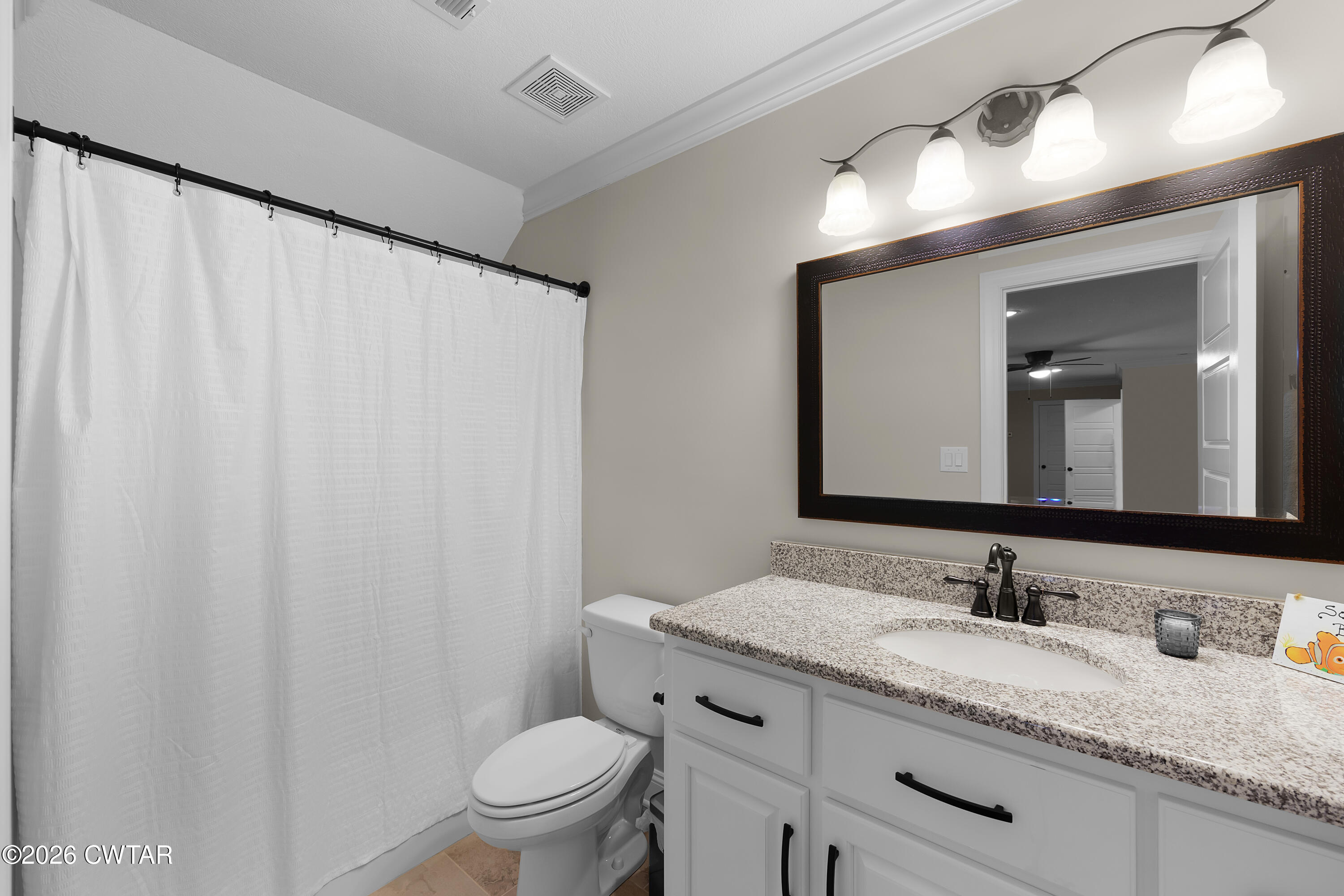 34 Cheddleton Cove Jackson, TN 38305 - Photo 24 of 32 a bathroom with a granite countertop sink a toilet and a mirror