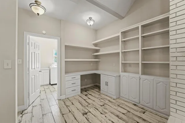 a utility room with cabinets washer and dryer