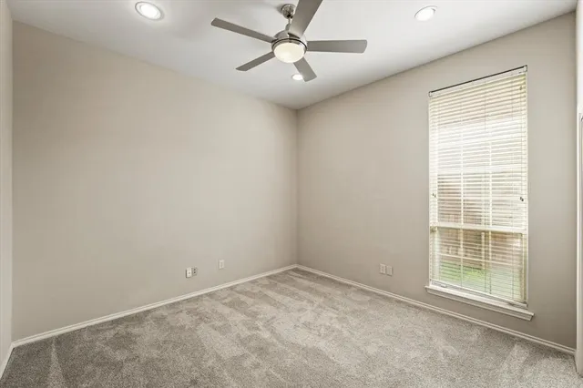 a view of an empty room with glass door